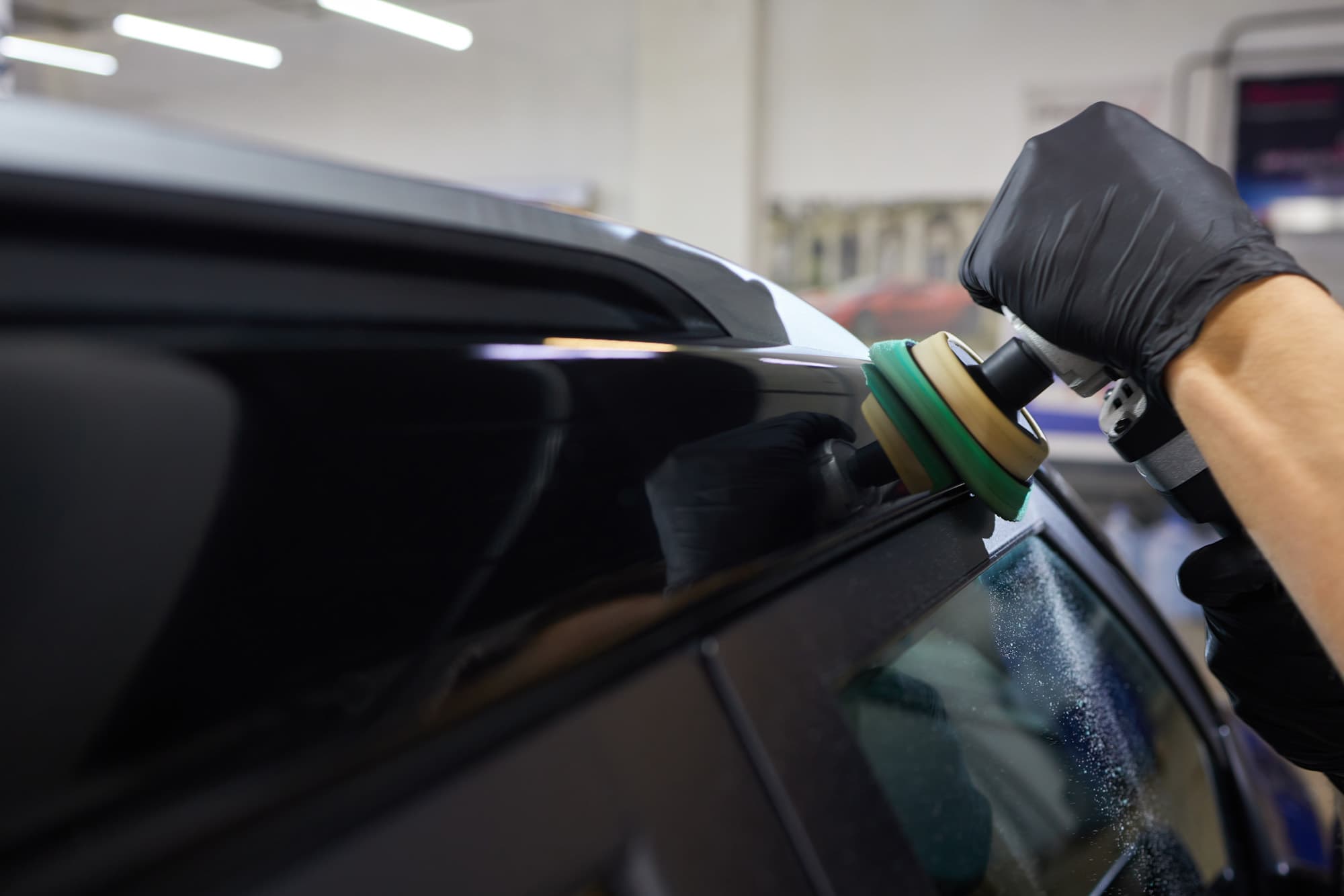 Man With Orbital Polisher Car Workshop Polishing Car Closeup Edited